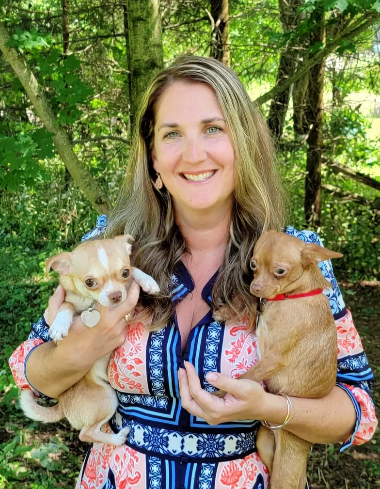 Woman holding 2 dogs